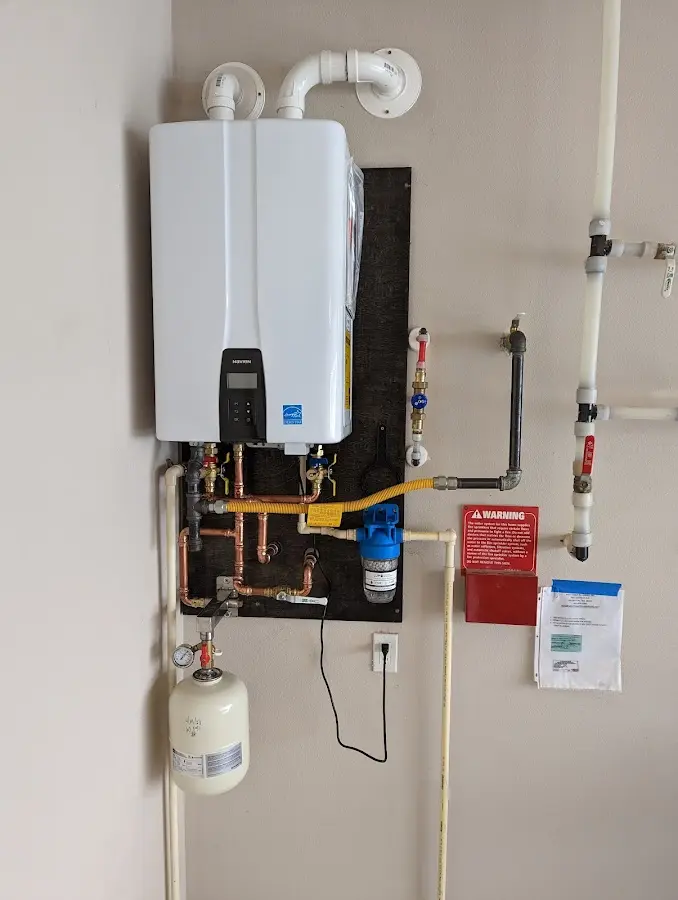 Professional plumber installing copper piping in a Bensville home